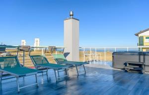 a group of chairs on the roof of a building at Piccolo Chalet Comfort E Stile in Marotta