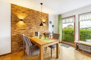 a dining room with a wooden table and chairs at Chalet Am Scheidt in Medebach +15 photos
