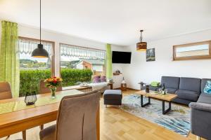 a living room with a table and a dining room at Chalet Am Scheidt in Medebach