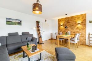 a living room with a couch and a table at Chalet Am Scheidt in Medebach