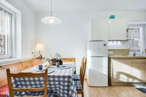 a kitchen with a table and a refrigerator at Ciasa Christina in Moena