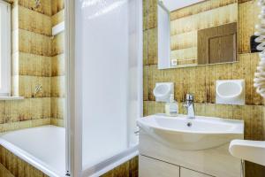 a bathroom with a sink and a shower at Ciasa Christina in Moena +21 photos
