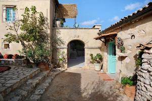 an entrance to a building with a blue door at Sira Stonehouse l in Volímai