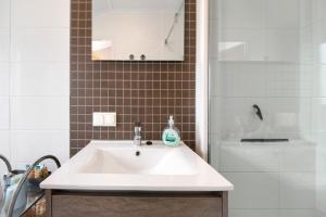 a bathroom with a white sink and a shower at Haus Ferdi in Koblenz +19 photos