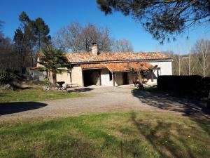 a house with a driveway in front of it at Maison De Campagne in Barbaste