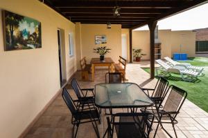 a patio with a table and chairs in a room at Villa Ralue in Tuineje