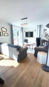 a living room with a couch and a table at Sublime Chalet 14 Pers Spa Extrieur in Cauterets