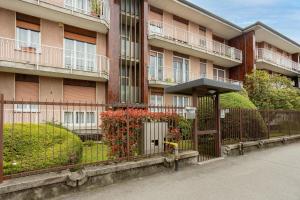 an apartment building with a fence in front of it at Suite 51 - Arona in Arona