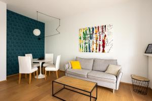 a living room with a couch and a table at Suite 51 - Arona in Arona