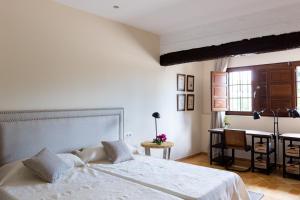 a bedroom with a white bed and a desk at Villa Monsalva in Monte San Miguel +36 photos