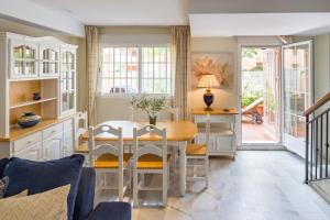 a kitchen with a table and chairs and a dining room at La Reserva de Alvarito in Marbella