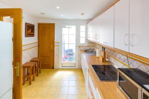 a kitchen with white cabinets and a wooden floor at La Reserva de Alvarito in Marbella +18 photos