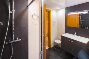 a bathroom with a sink and a shower with a mirror at La Reserva de Alvarito in Marbella