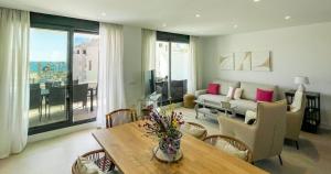 a living room with a table and a couch at Flat Sun Garden in Torrox