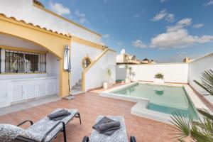a patio with a swimming pool and a house at Villa Sueño in Mazarrón