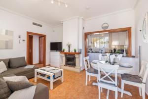 a living room with a couch and a table and a kitchen at Villa Sueño in Mazarrón