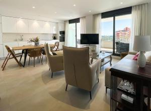 a living room with a table and a dining room at Flat Sun Garden in Torrox