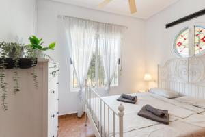 a white bedroom with a bed and a window at Villa Sueño in Mazarrón +22 photos