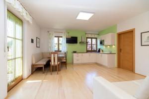 a kitchen and dining room with green and white walls at Stompferhof Familienapartment in Caldaro