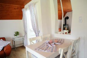 a dining room with a white table and chairs at Ferienhaus Friedrichskoog - Spitze in Friedrichskoog-Spitze
