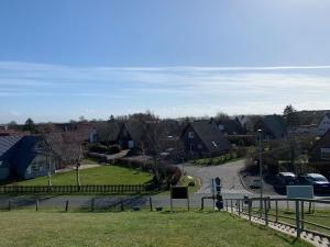 a view of a residential neighborhood with houses and a street at Ferienhaus Friedrichskoog - Spitze in Friedrichskoog-Spitze +8 photos