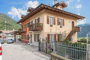 a house with a fence in front of it at Appartamento Le Quattro Stagioni in Levico Terme