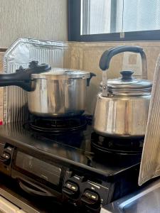 a pair of pots and pans on a stove at 明月民宿 in Takatsuki +15 photos