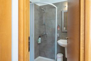 a bathroom with a shower and a sink at Calliope Maille Family House in Kalymnos +13 photos