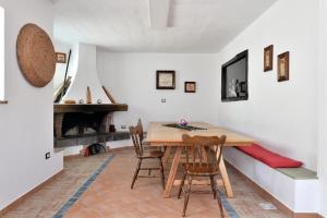 a dining room with a wooden table and chairs at Casa Ami in Arzana