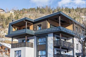 a house with balconies on the side of it at Apartments Armeri Blue Dolomites in San Vigilio Di Marebbe