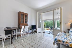 a living room with a table and chairs and a dining room at Casa Camilla in Procchio