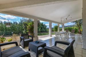 a living room with chairs and a table with a view at Casa Camilla in Procchio