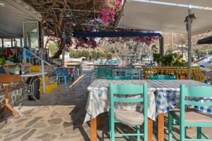 a table and chairs at a restaurant with flowers at Hotel Galini in Kalymnos
