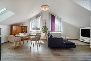 a living room with a table and chairs at Loft Schwenck in Kressbronn am Bodensee