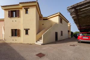 a house with a staircase in a parking lot at Casa Vacanze Susino in Olbia