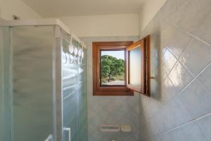 a bathroom with a shower and a window at Casa Vacanze Susino in Olbia +14 photos