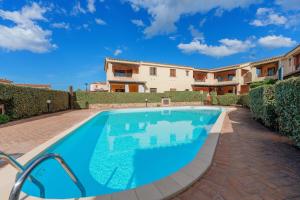 a swimming pool in front of a house at Casa Vacanze Susino in Olbia