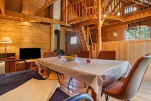 a dining room with a white table and chairs at Blockbohlen-Haus auf Hof Verchen in Verchen