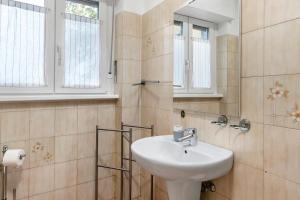 a bathroom with a sink and a mirror at Appartamento Spormaggiore in Spormaggiore +19 photos