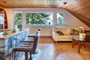 a living room with a couch and a table at Ferienwohnung Klee in Fedderwarden