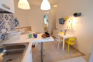 a kitchen with a sink and a table at Casa Vacanze Maya a Otranto in Otranto