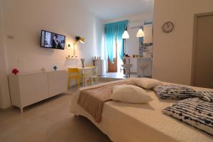 a bedroom with a large bed and a dining room at Casa Vacanze Maya a Otranto in Otranto