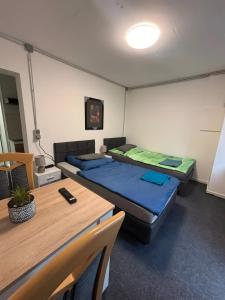 a room with two beds and a table at Menzel Appartment W1 in Beckingen