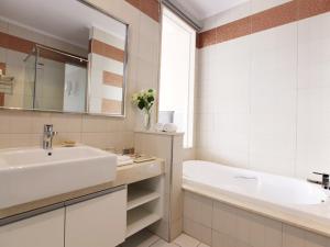 a white bathroom with a sink and a tub and a tubermott at Yundeng Landscape Hotel in Fanlu