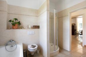 a bathroom with a toilet and a tub and a sink at Ferienwohnung Bestensee in Bestensee
