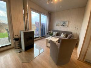 a living room with a couch and a fireplace at Skipper Hus by Seeblick Ferien in Olpenitz