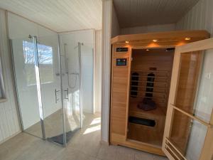 a walk in shower in a bathroom with a glass shower stall at Skipper Hus by Seeblick Ferien in Olpenitz +21 photos