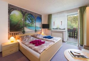 a bedroom with a bed with towels on it at Gruppenferienhaus Dressel in Warmensteinach