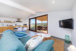 a living room with a blue couch and a tv at Can Jaume in Manacor