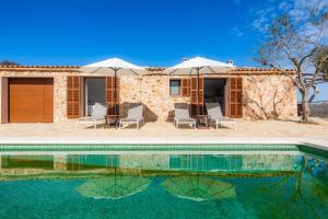 a villa with a pool in front of a house at Can Jaume in Manacor